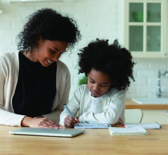 A parent and child working together at a table